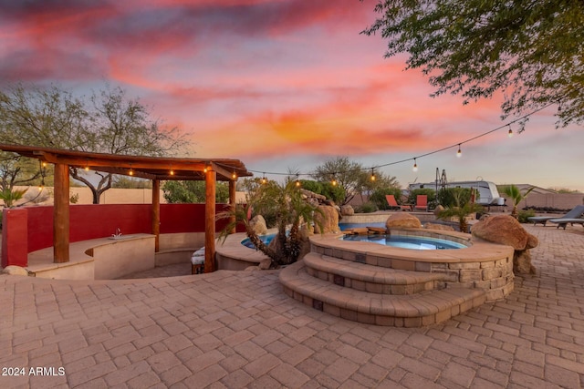 patio terrace at dusk with an in ground hot tub