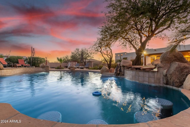 pool at dusk with pool water feature