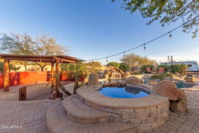 view of patio with a pool with hot tub