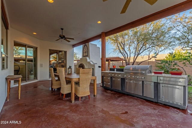 patio terrace at dusk featuring ceiling fan, a grill, and area for grilling