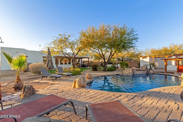 view of swimming pool featuring pool water feature and a patio area