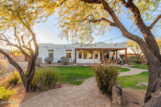 rear view of property featuring a yard