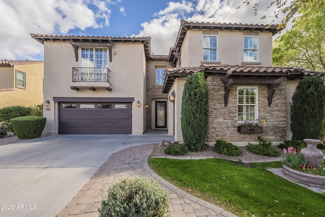 mediterranean / spanish-style house featuring stucco siding, stone siding, concrete driveway, an attached garage, and a balcony