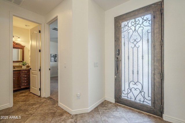 entryway with visible vents, plenty of natural light, and baseboards