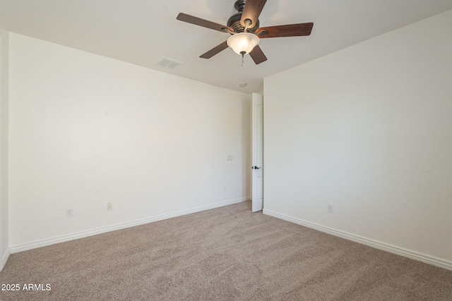 unfurnished room with baseboards, light colored carpet, visible vents, and ceiling fan