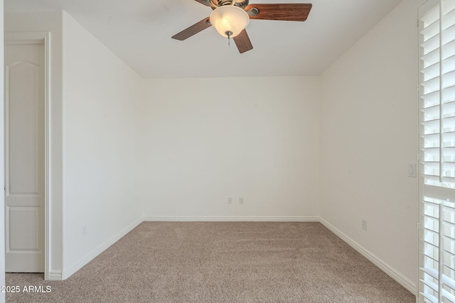 unfurnished room featuring carpet flooring, baseboards, and a ceiling fan