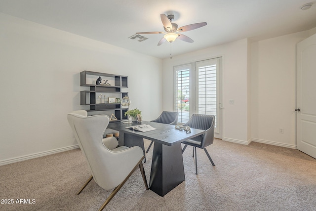 carpeted dining room featuring visible vents, baseboards, and a ceiling fan