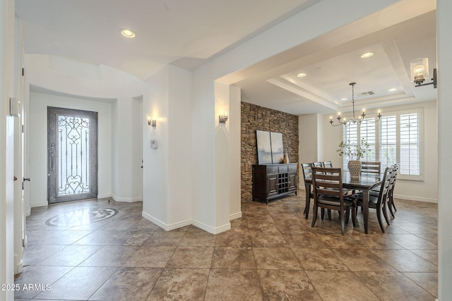 dining room with baseboards, visible vents, a tray ceiling, recessed lighting, and a chandelier