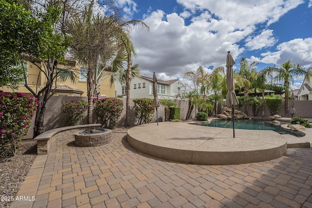 exterior space featuring a fenced backyard, a fenced in pool, and a fire pit