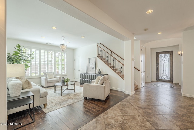 living room with stairway, wood finished floors, visible vents, baseboards, and recessed lighting