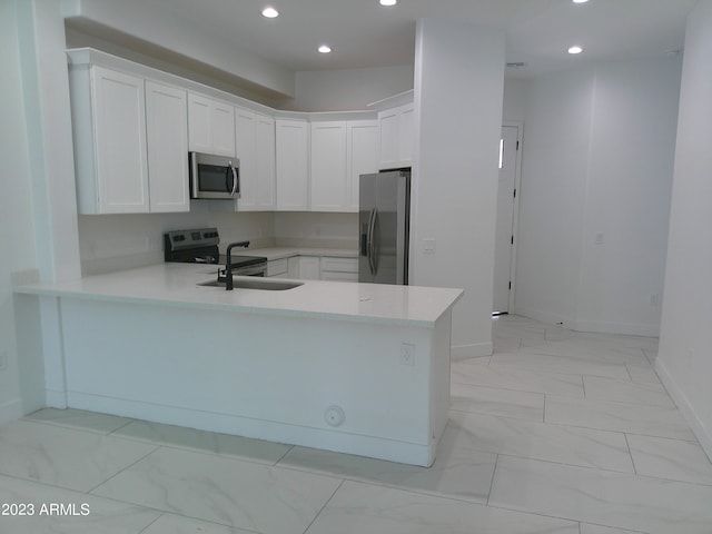 kitchen featuring white cabinetry, light tile floors, stainless steel appliances, kitchen peninsula, and sink