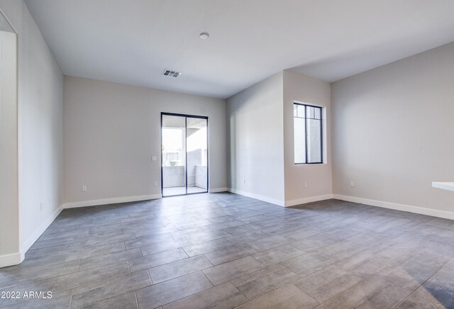 empty room featuring plenty of natural light and light tile floors