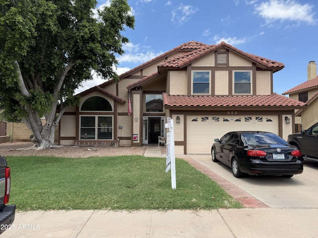 956 N 58th St, Mesa, AZ 85205 - view of front facade with driveway, an attached garage, stucco siding, a front yard, and a tiled roof