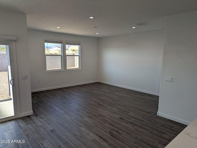 spare room featuring dark wood-type flooring