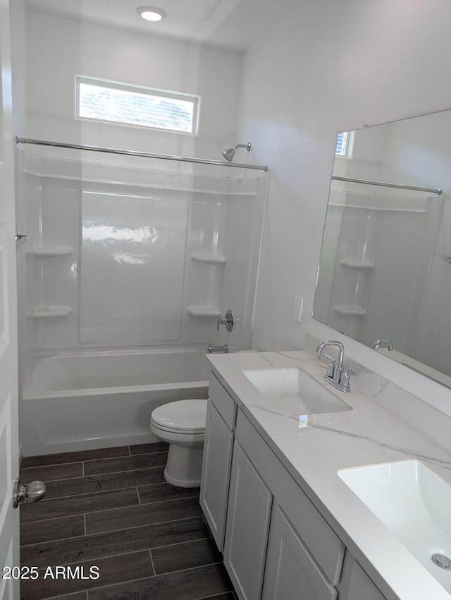 full bathroom featuring toilet, vanity, and bathtub / shower combination