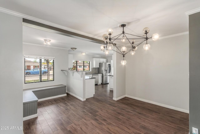 2938 N 18th Ave, Phoenix, AZ 85015 - kitchen with stainless steel appliances, white cabinets, a peninsula, dark wood-type flooring, and a chandelier