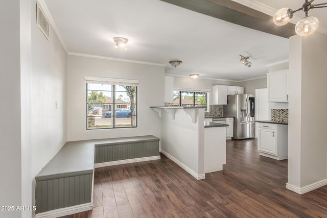 2938 N 18th Ave, Phoenix, AZ 85015 - kitchen with stainless steel refrigerator with ice dispenser, white cabinets, backsplash, a peninsula, and dark wood-style floors