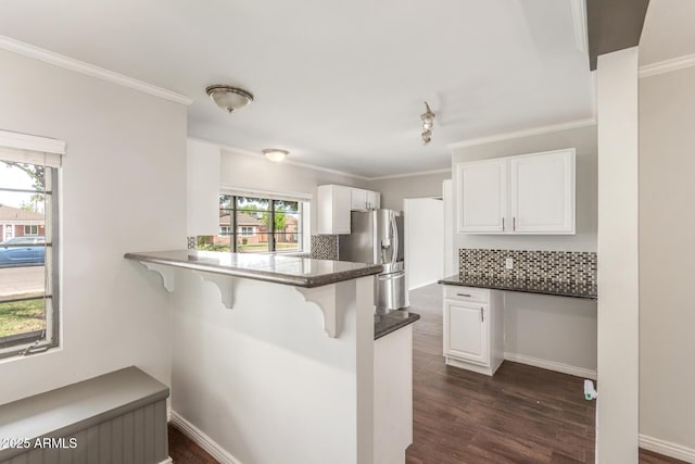 2938 N 18th Ave, Phoenix, AZ 85015 - kitchen with stainless steel fridge with ice dispenser, a breakfast bar area, backsplash, white cabinets, and dark wood finished floors