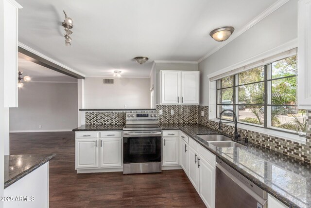 2938 N 18th Ave, Phoenix, AZ 85015 - kitchen with appliances with stainless steel finishes, a sink, backsplash, ornamental molding, and dark stone countertops