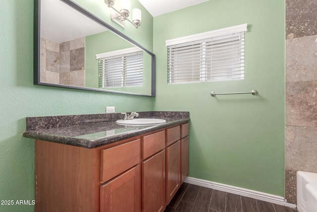 2938 N 18th Ave, Phoenix, AZ 85015 - full bath with vanity, baseboards, a bathtub, and wood finished floors