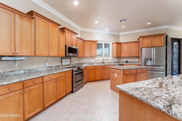 7969 S 172nd St, Queen Creek, AZ 85142 - kitchen featuring appliances with stainless steel finishes, light stone countertops, ornamental molding, light tile patterned floors, and a center island