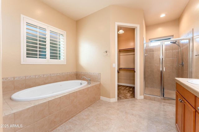 7969 S 172nd St, Queen Creek, AZ 85142 - bathroom featuring a stall shower, vanity, a garden tub, a walk in closet, and tile patterned floors