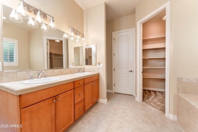 7969 S 172nd St, Queen Creek, AZ 85142 - bathroom featuring tile patterned flooring, double vanity, a spacious closet, and a chandelier