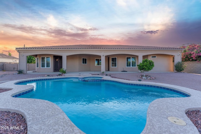 7969 S 172nd St, Queen Creek, AZ 85142 - pool at dusk featuring fence, a patio area, and a pool with connected hot tub