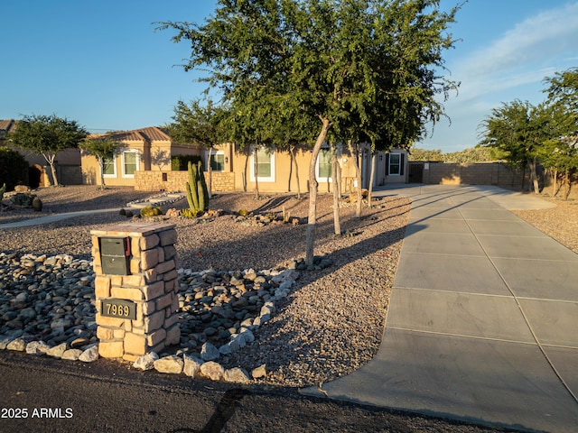 7969 S 172nd St, Queen Creek, AZ 85142 - obstructed view of property featuring concrete driveway, fence, and stucco siding