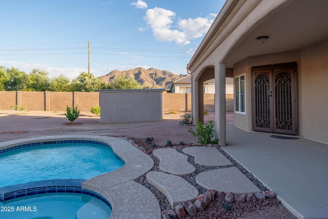 7969 S 172nd St, Queen Creek, AZ 85142 - view of pool with a mountain view, a patio area, a fenced backyard, and a pool with connected hot tub