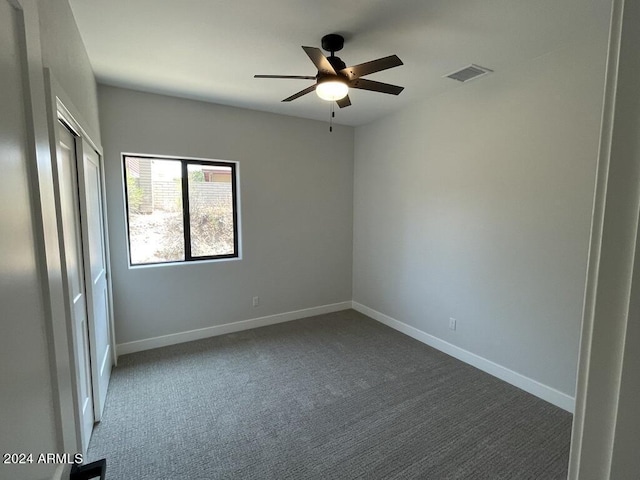 carpeted empty room with ceiling fan