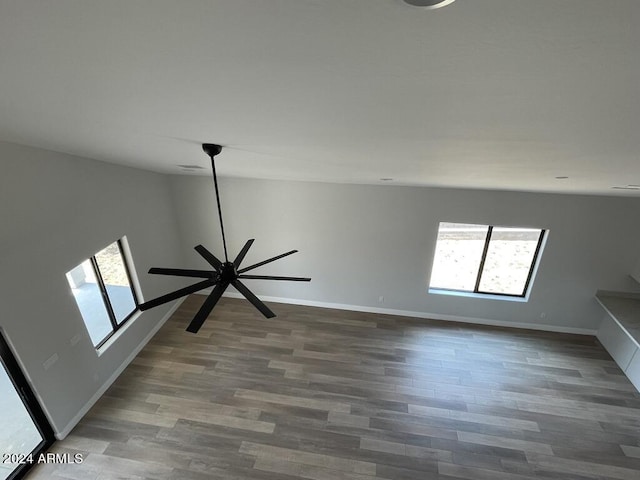 empty room featuring dark wood-type flooring and a wealth of natural light