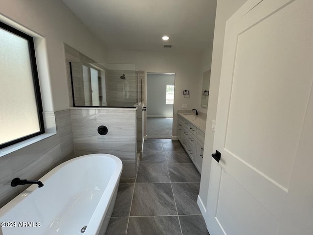 bathroom with vanity, tile patterned flooring, and shower with separate bathtub