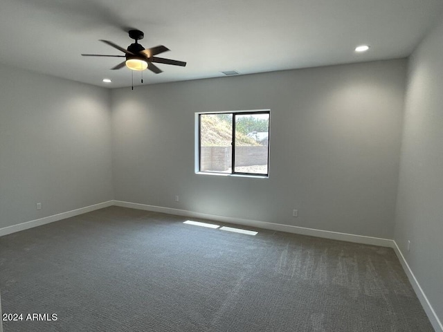 carpeted spare room featuring ceiling fan