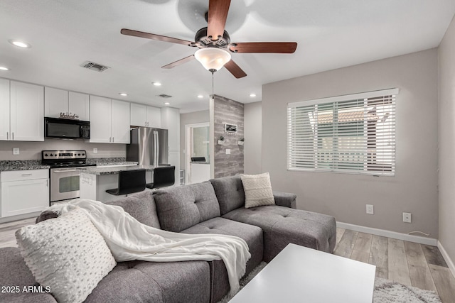 520 N Stapley Dr Unit 286, Mesa, AZ 85203 - living area featuring a ceiling fan, visible vents, baseboards, recessed lighting, and light wood-style floors
