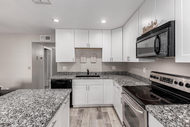 520 N Stapley Dr Unit 286, Mesa, AZ 85203 - kitchen featuring visible vents, black appliances, a sink, stone countertops, and white cabinets