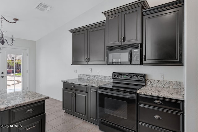 kitchen with light tile patterned floors, light stone counters, a notable chandelier, visible vents, and black appliances