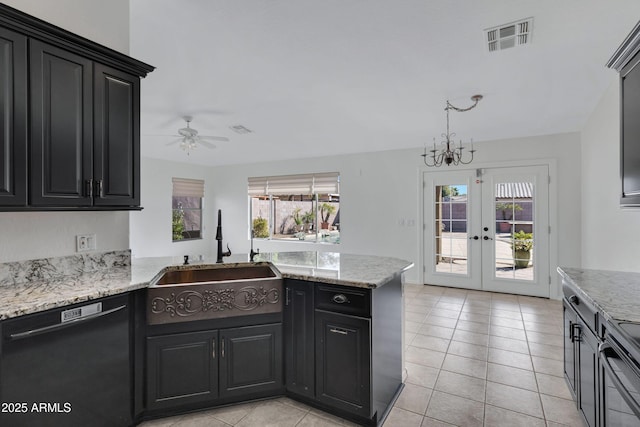 kitchen with dishwasher, a sink, visible vents, and dark cabinets