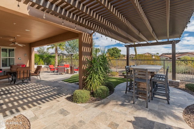 view of patio / terrace featuring ceiling fan and a pergola