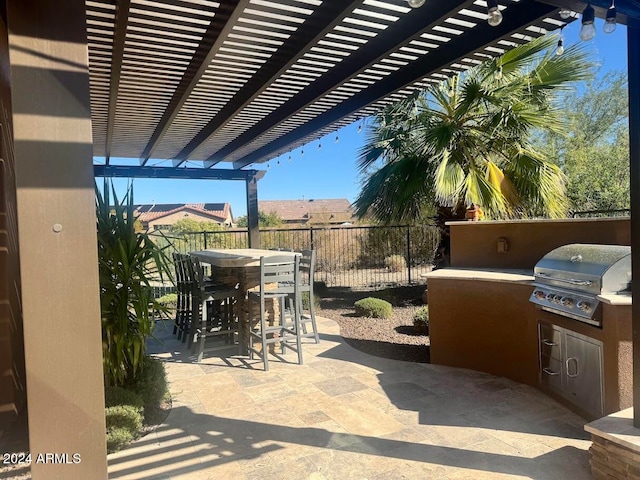 view of patio with a pergola, area for grilling, a bar, and exterior kitchen