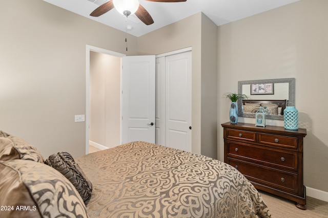 bedroom featuring a closet, ceiling fan, and light carpet