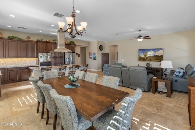 dining room featuring ceiling fan with notable chandelier