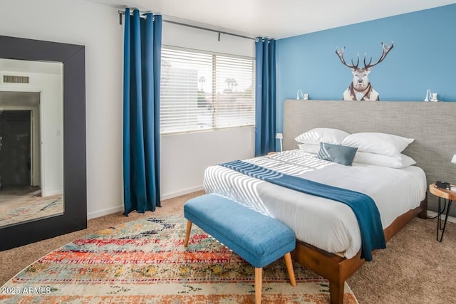 carpeted bedroom featuring visible vents and baseboards