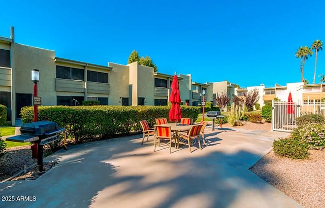 4610 N 68th St Unit 402, Scottsdale, AZ 85251 - view of patio / terrace with a residential view, outdoor dining area, and a grill