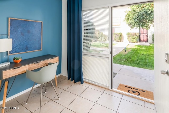 entryway with baseboards and tile patterned floors