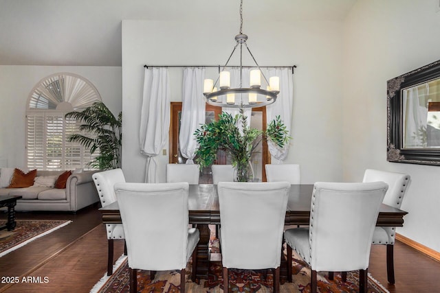 dining room featuring dark hardwood / wood-style floors and an inviting chandelier