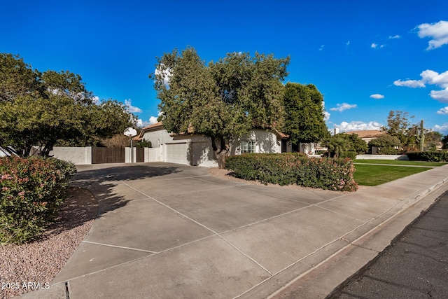 view of property hidden behind natural elements with a garage