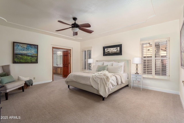 bedroom featuring connected bathroom, light carpet, and ceiling fan