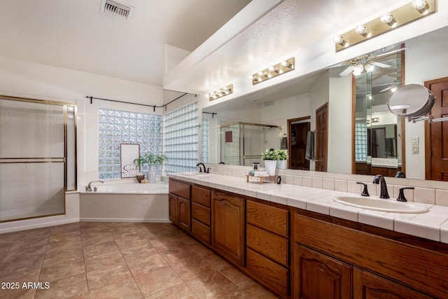 bathroom with tile patterned flooring, vanity, separate shower and tub, and ceiling fan