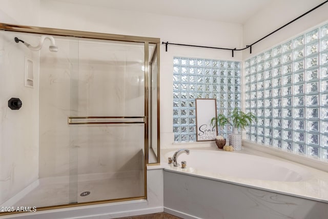 bathroom featuring separate shower and tub